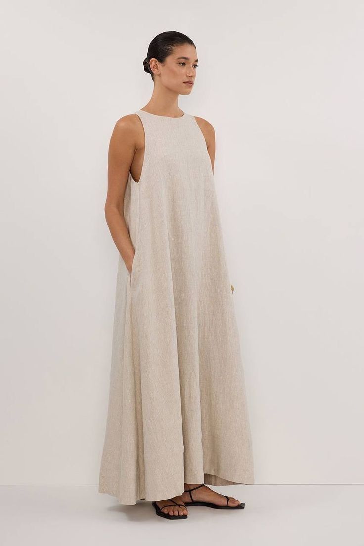 Woman in a sleeveless natural linen maxi dress