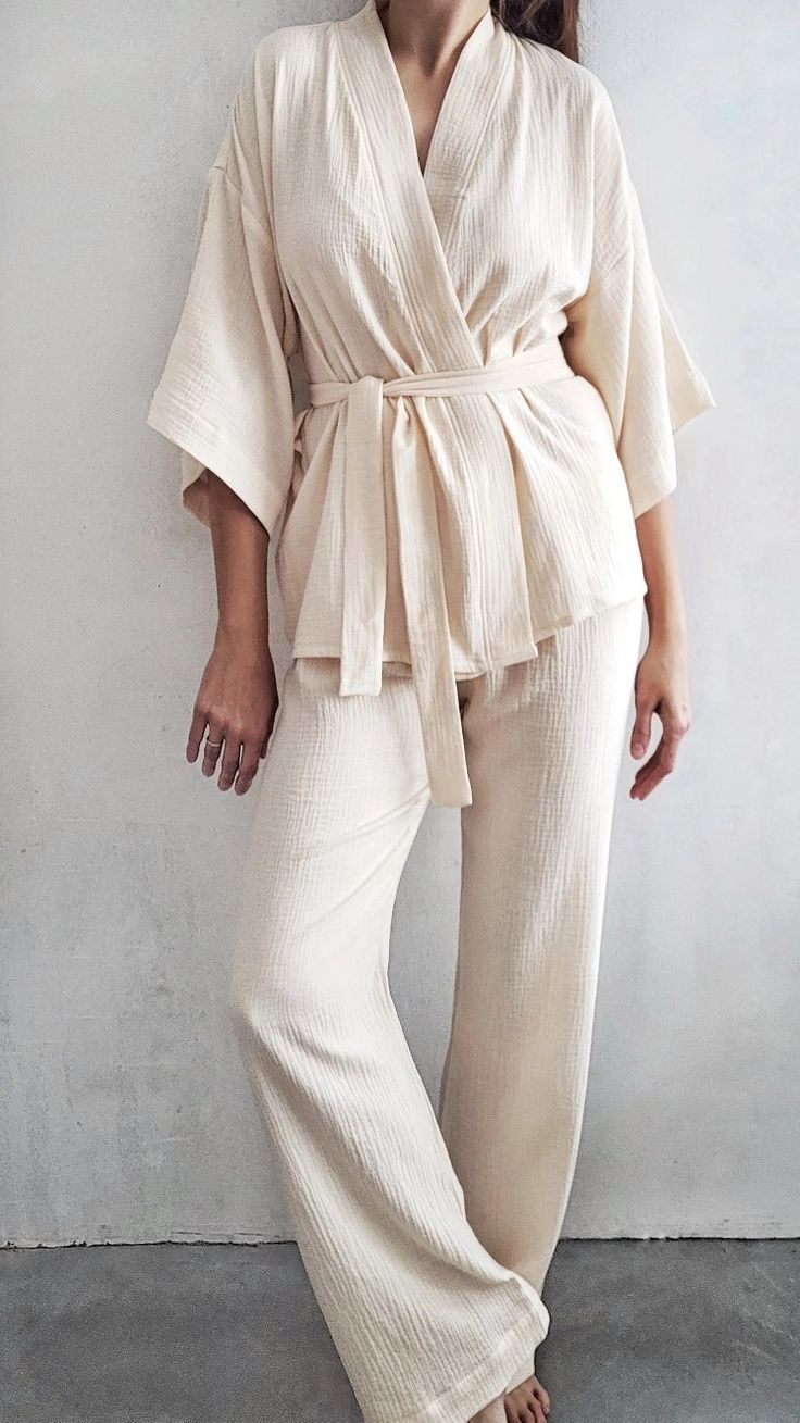 Woman in a cream linen wrap top and wide trousers